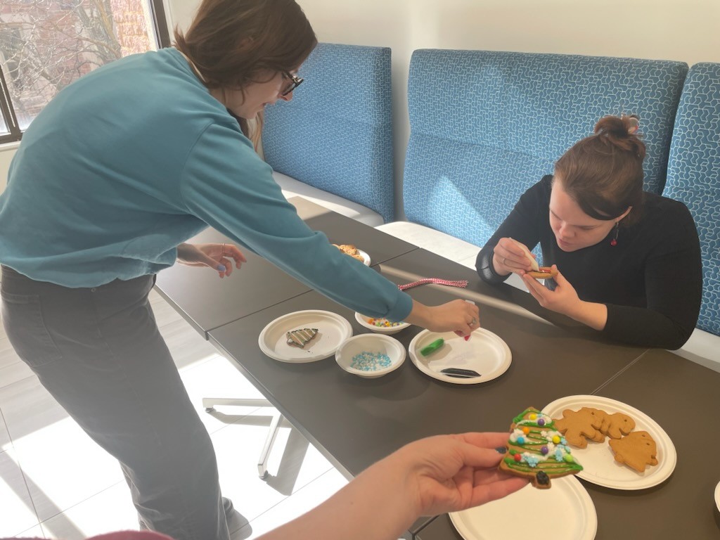 Two women decorate cookies