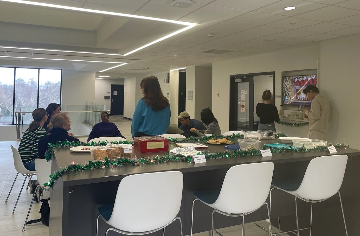 Nine people from the SDS department smile at the camera, surrounded by food