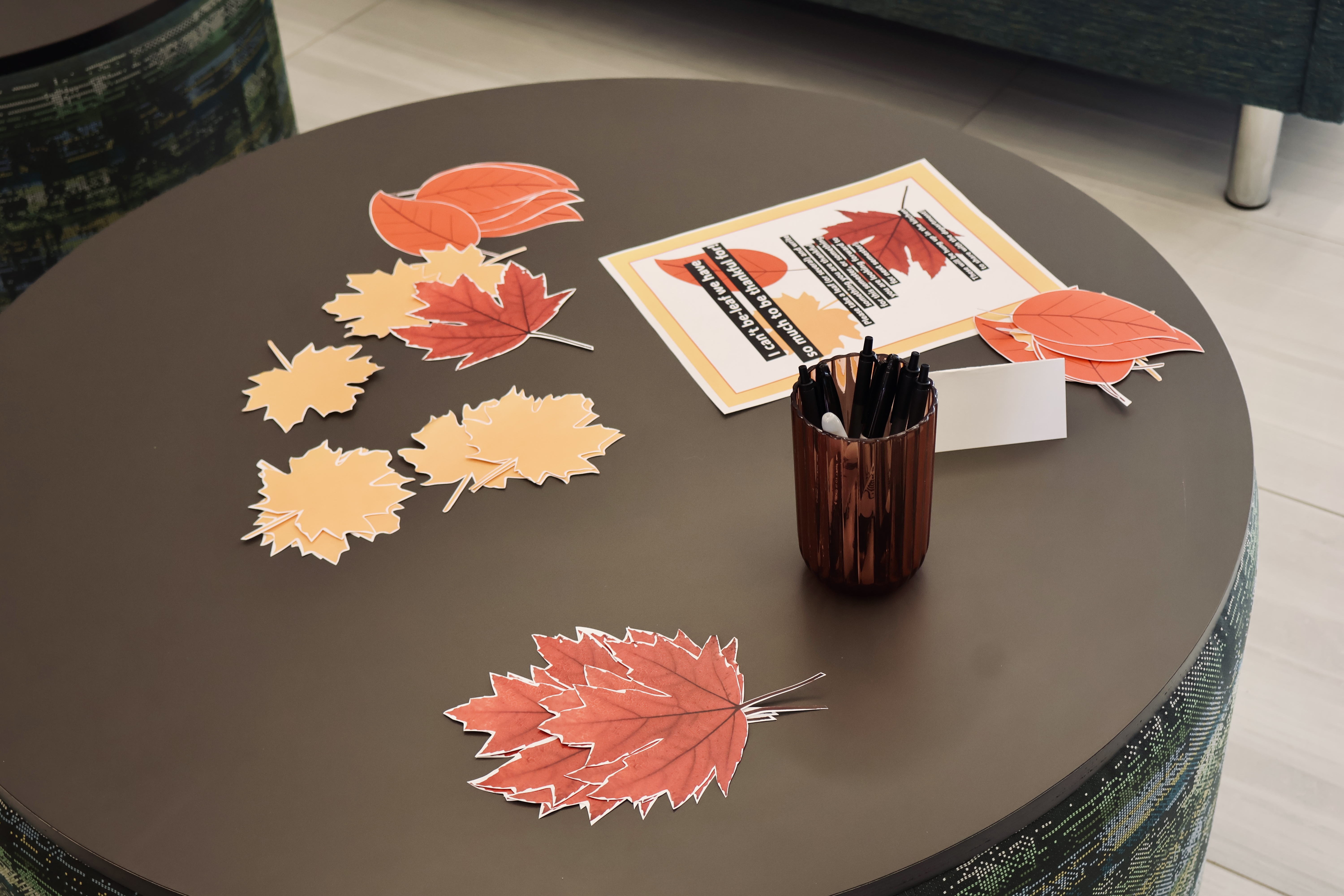 A table with paper leaves and writing utensils