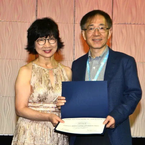 American Statistical Association President Ji-Hyun Lee presents Xuming He with the Noether Distinguished Scholar award 