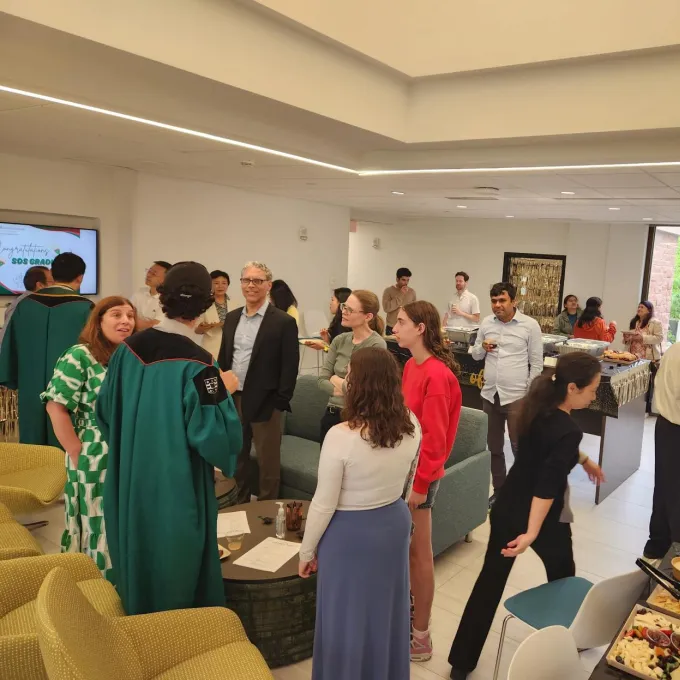 Students, their families, and professors eat and chat in the Jolley Hall fifth floor lobby