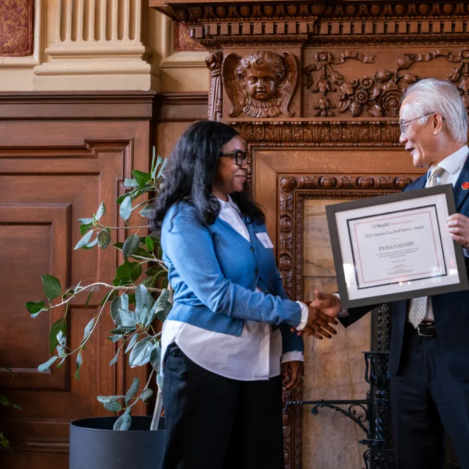 Arts & Sciences Dean Feng Sheng Hu presents Fiona Vaughn with the 2025 Outstanding Staff Service Award
